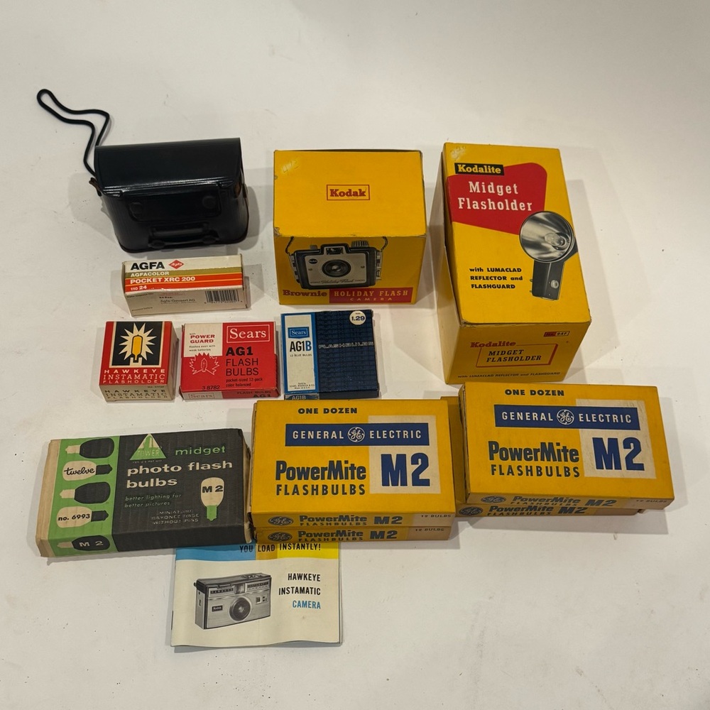 Vintage Hawkeye Instamatic camera and Holiday Flash Camera with accessories.